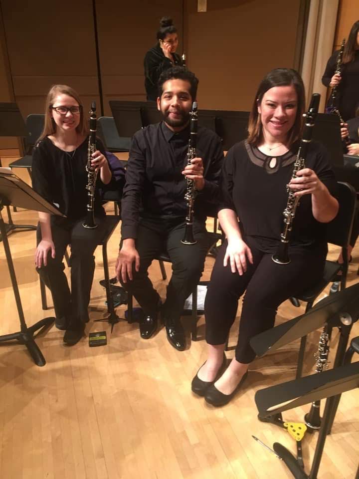 Students Amy Gravell and Noah Ornelas smile with alumn Bethany Lee during the final performance.