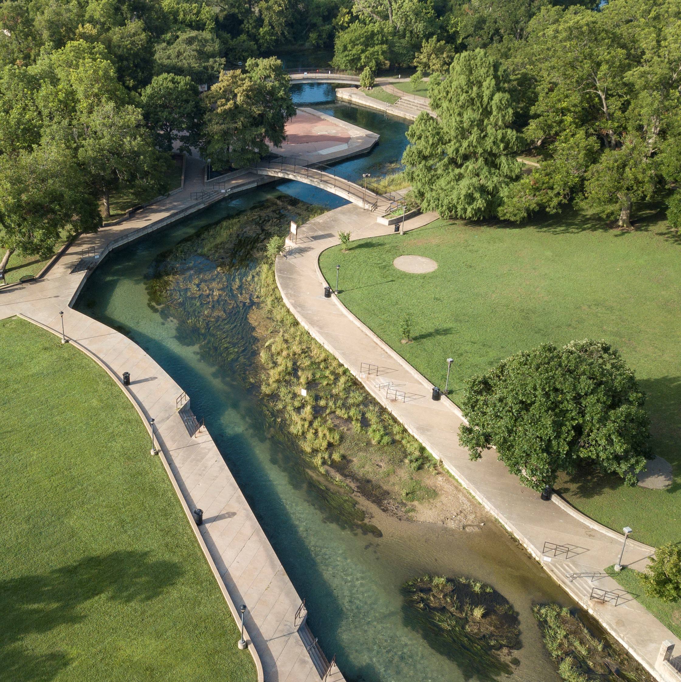 Picture showing an aerial view of the San Marcos River flowing through Sewell Park.