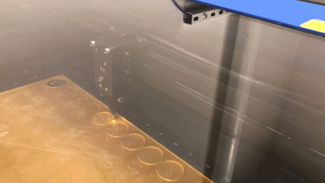 a laser cutter cutting circles