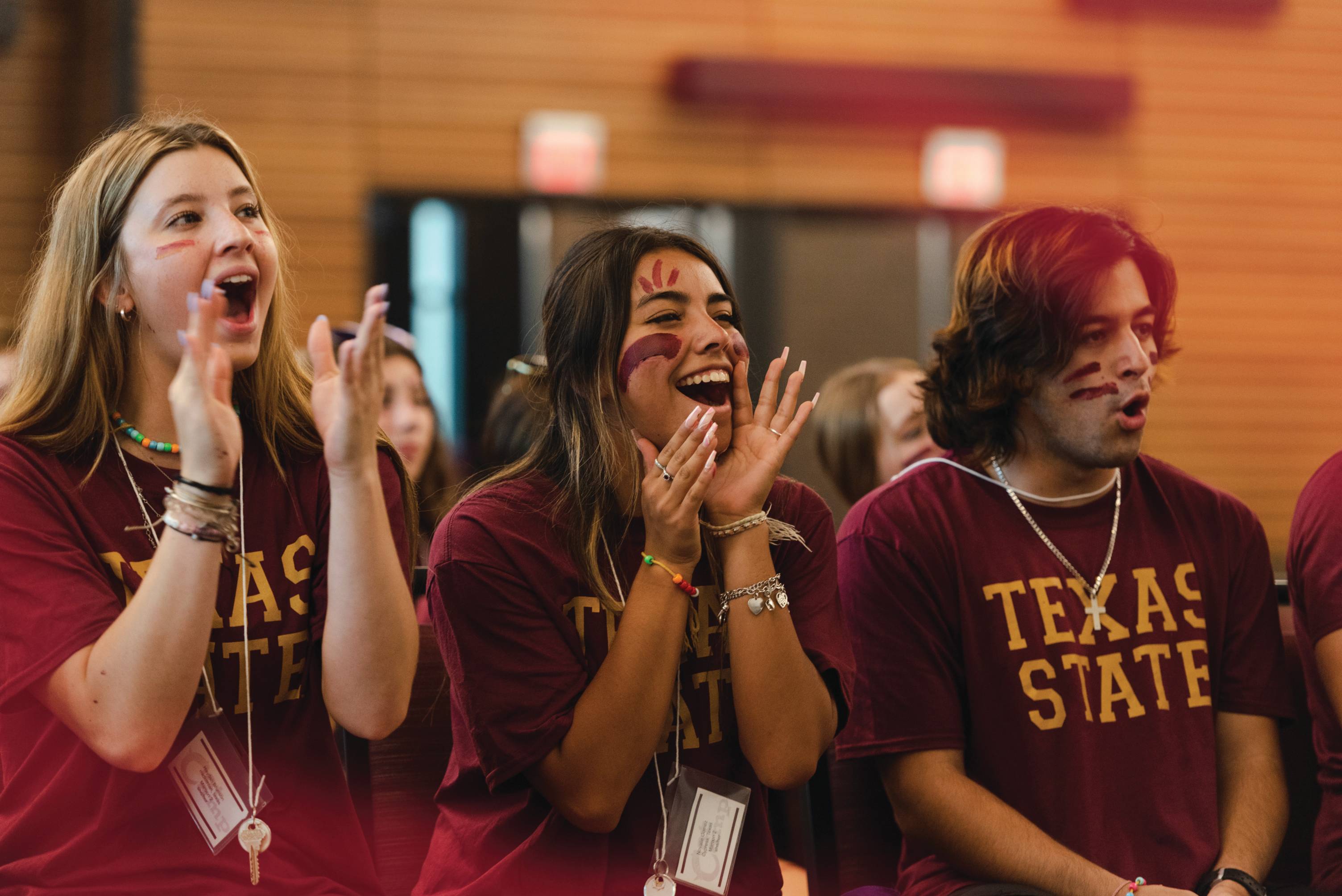 Texas State University students cheering at an event.