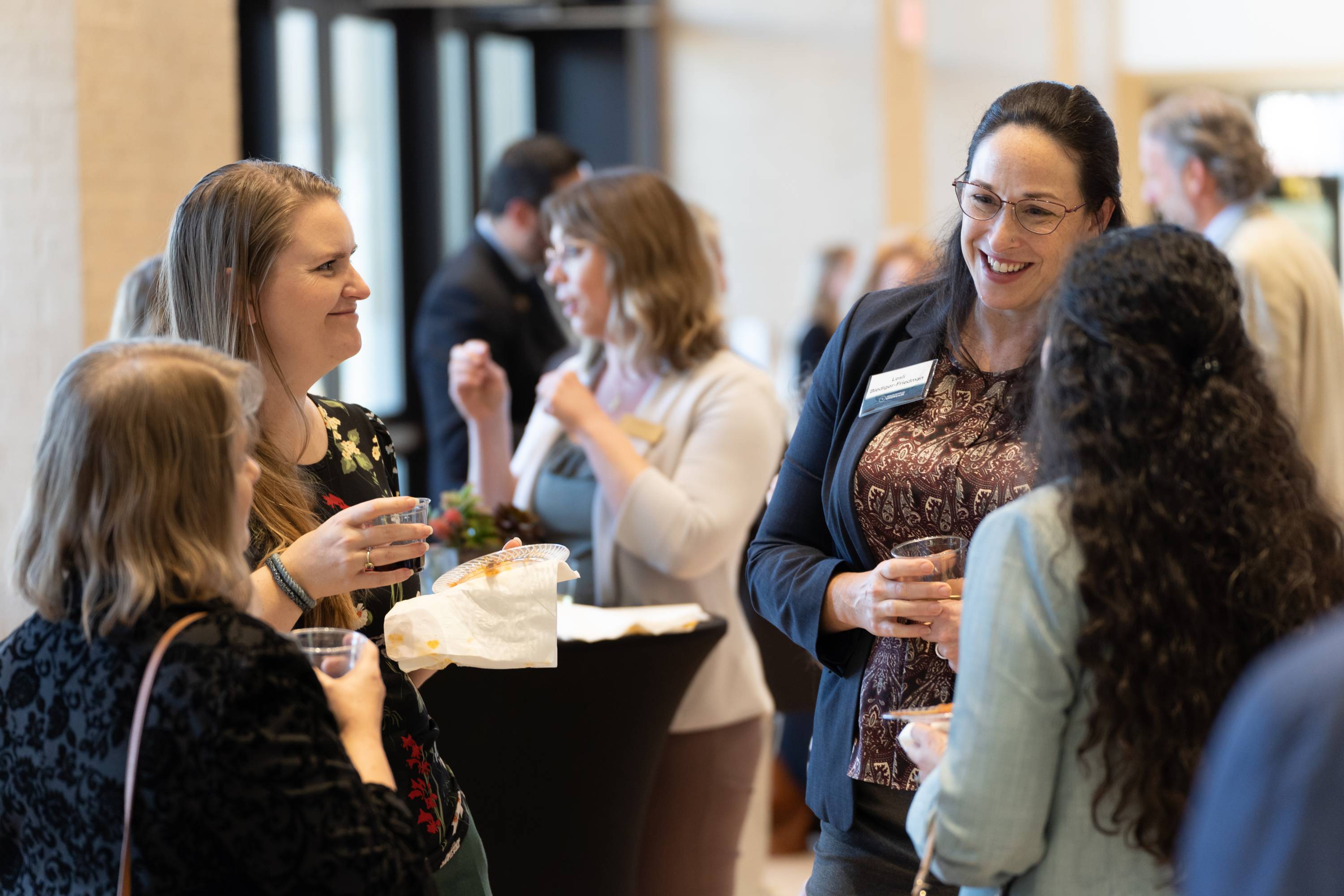 Attendees and researchers mingle with food a drink at the networking portion of the Showcase.