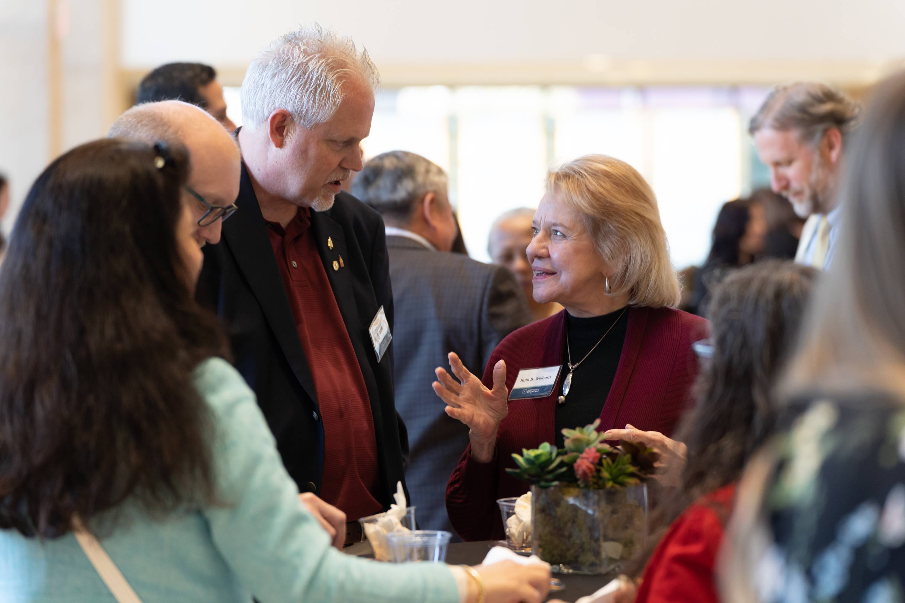 Attendees and researchers mingle with food a drink at the networking portion of the Showcase.