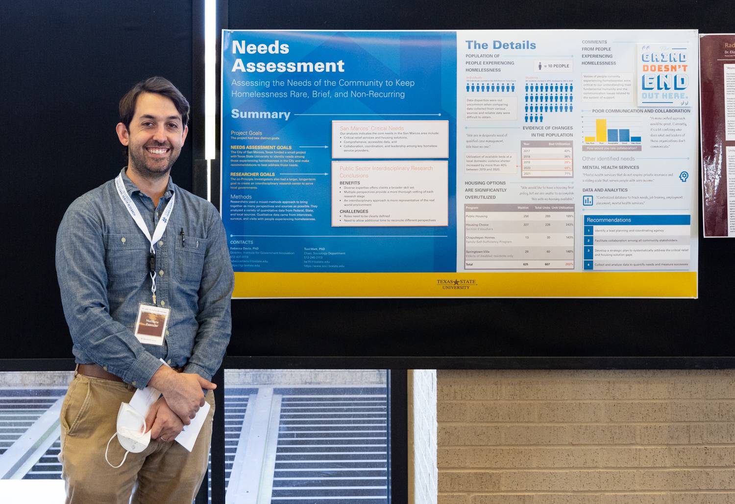 Researcher standing in front of a research poster at Health Scholar Showcase 2022