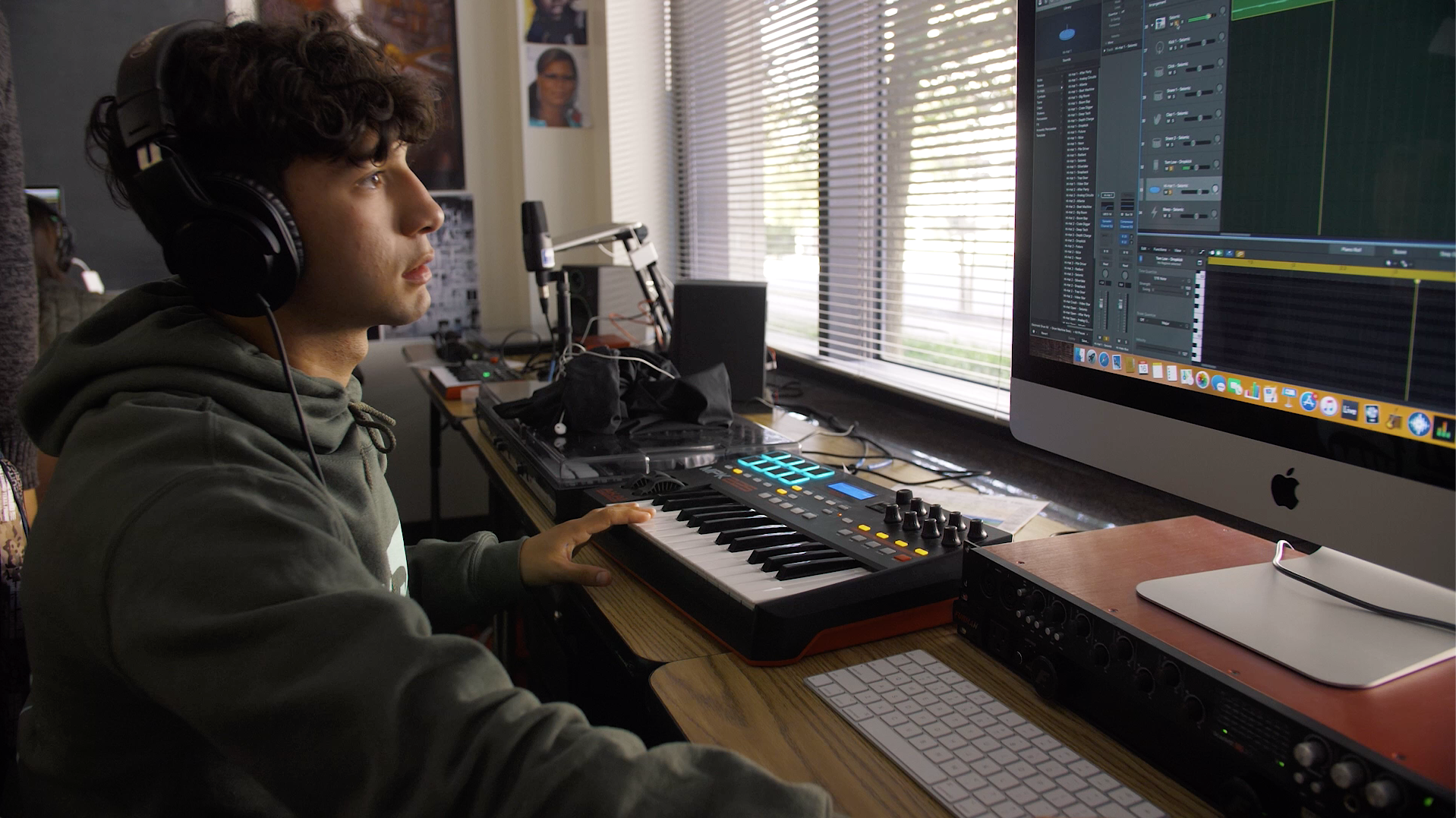 Male student learning music production with Upward Bound
