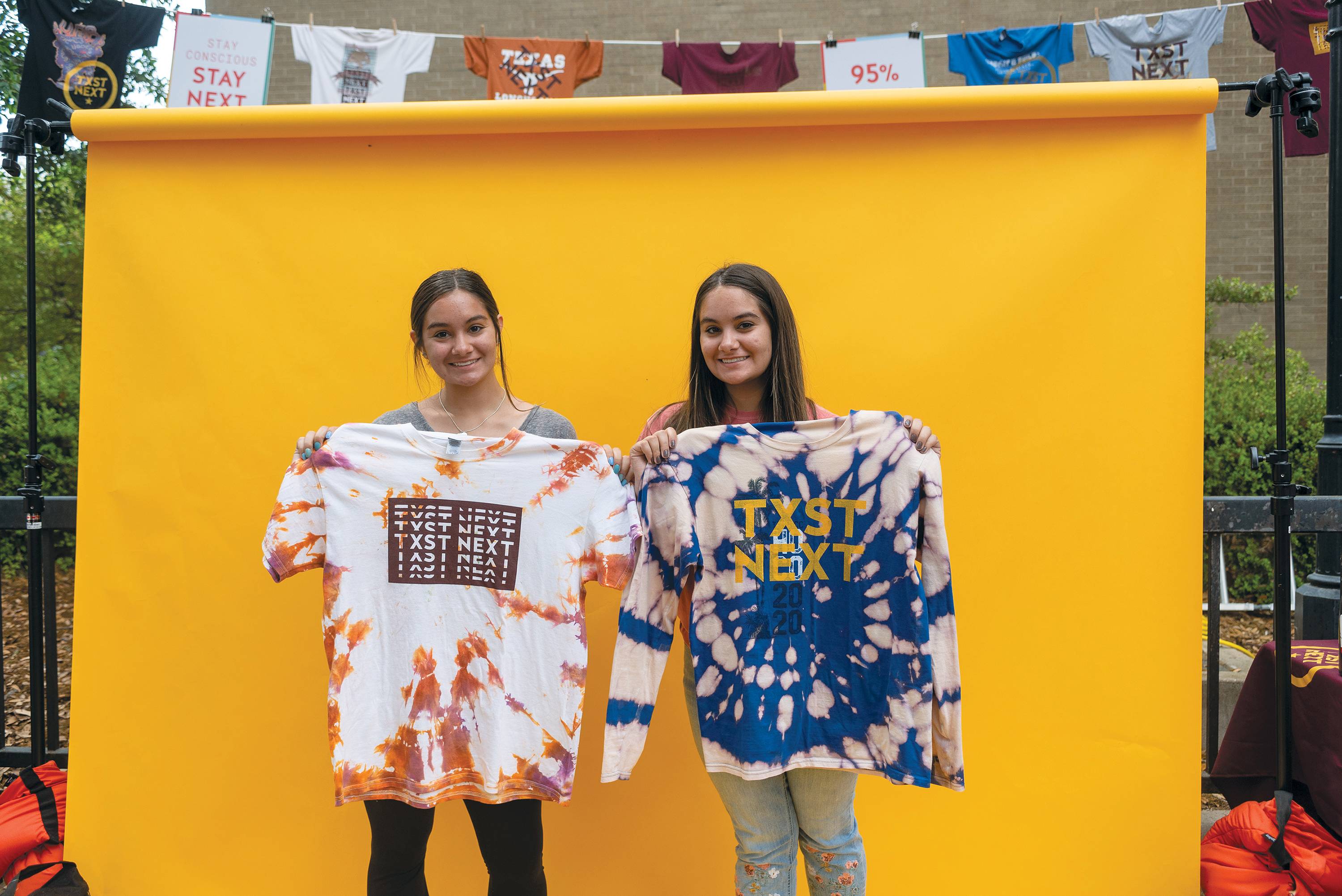Students pose with the tie-dyed shirts they got screen-printed with TXST Next designs during the Wear Next event.