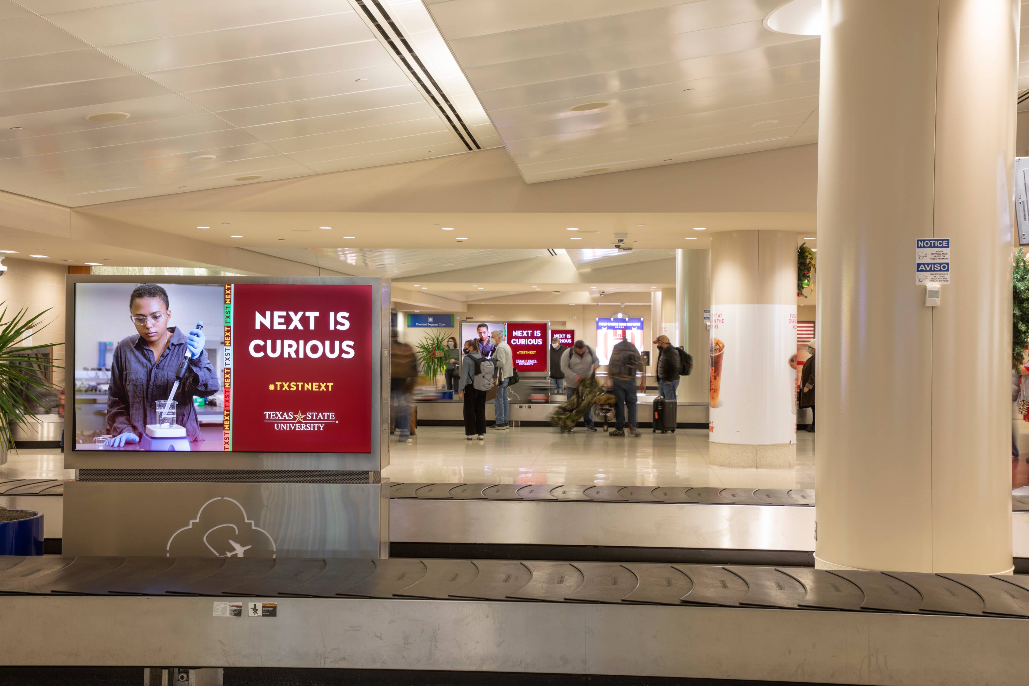 TXST Next airport ads displayed at baggage claim screens