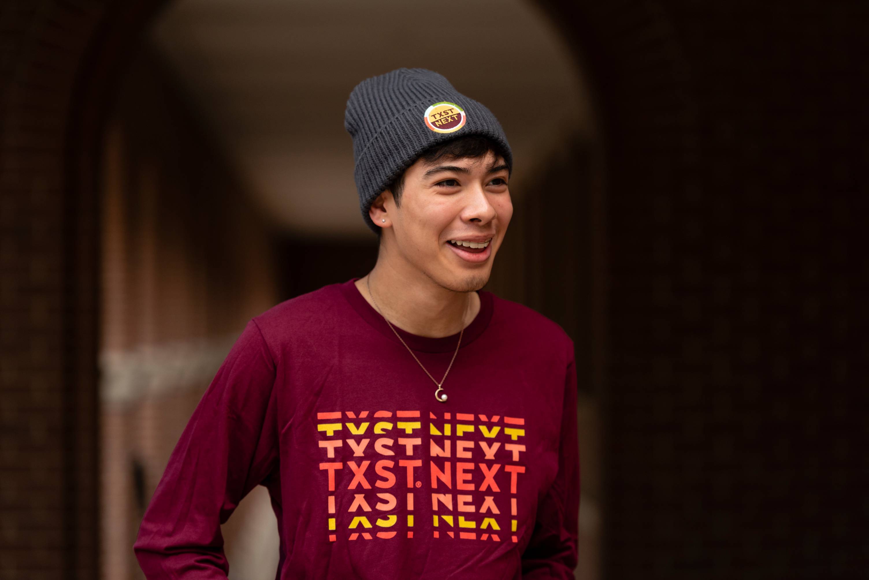 Texas State Student Wearing TXST NEXT merchandise.