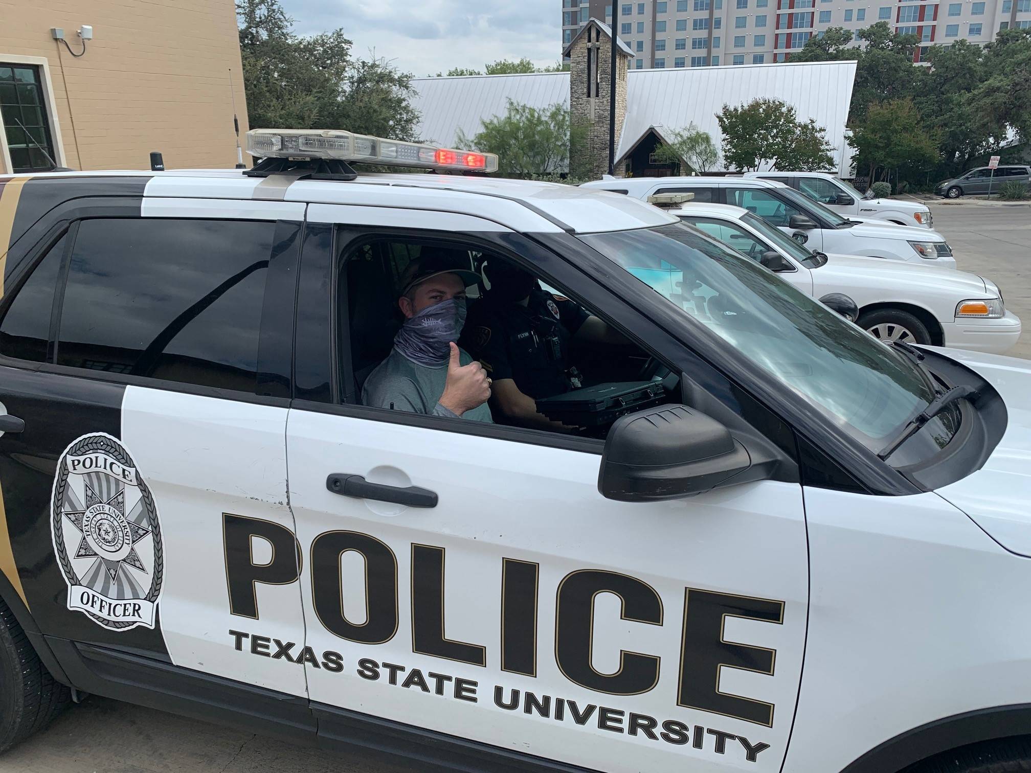 Student with Thumbs Up in UPD Vehicle