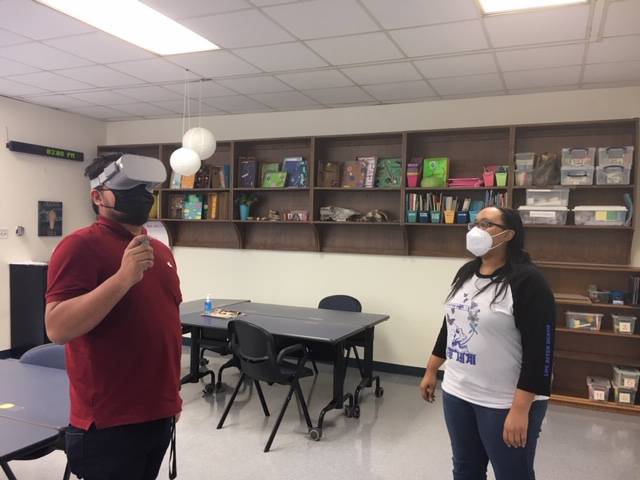 Teacher in classroom using virtual reality