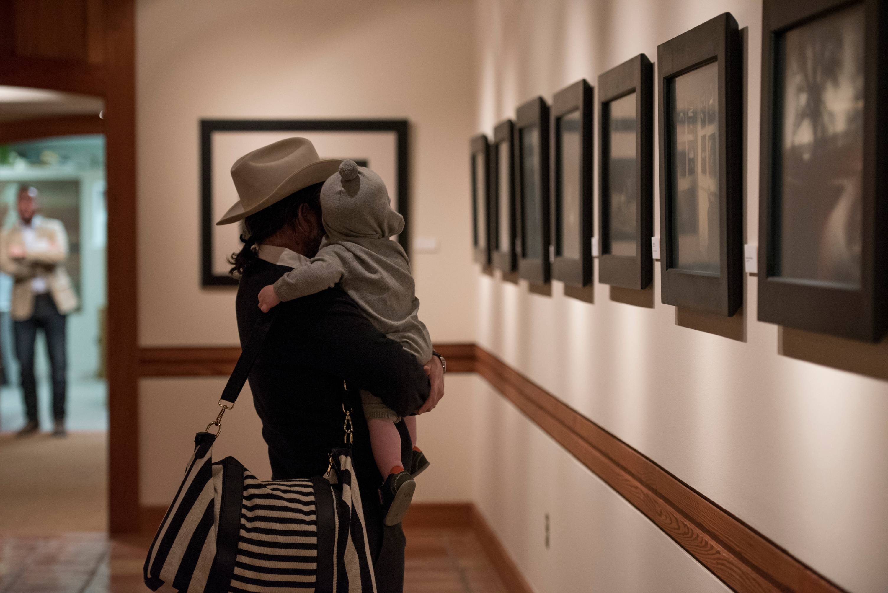 Photo of man and child in a gallery