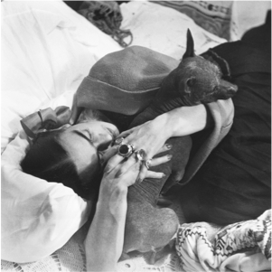 Frida Kahlo hugging one of her xoloescuintles, Coyoacan, Ciudad de Mexico, 1952 by Héctor García