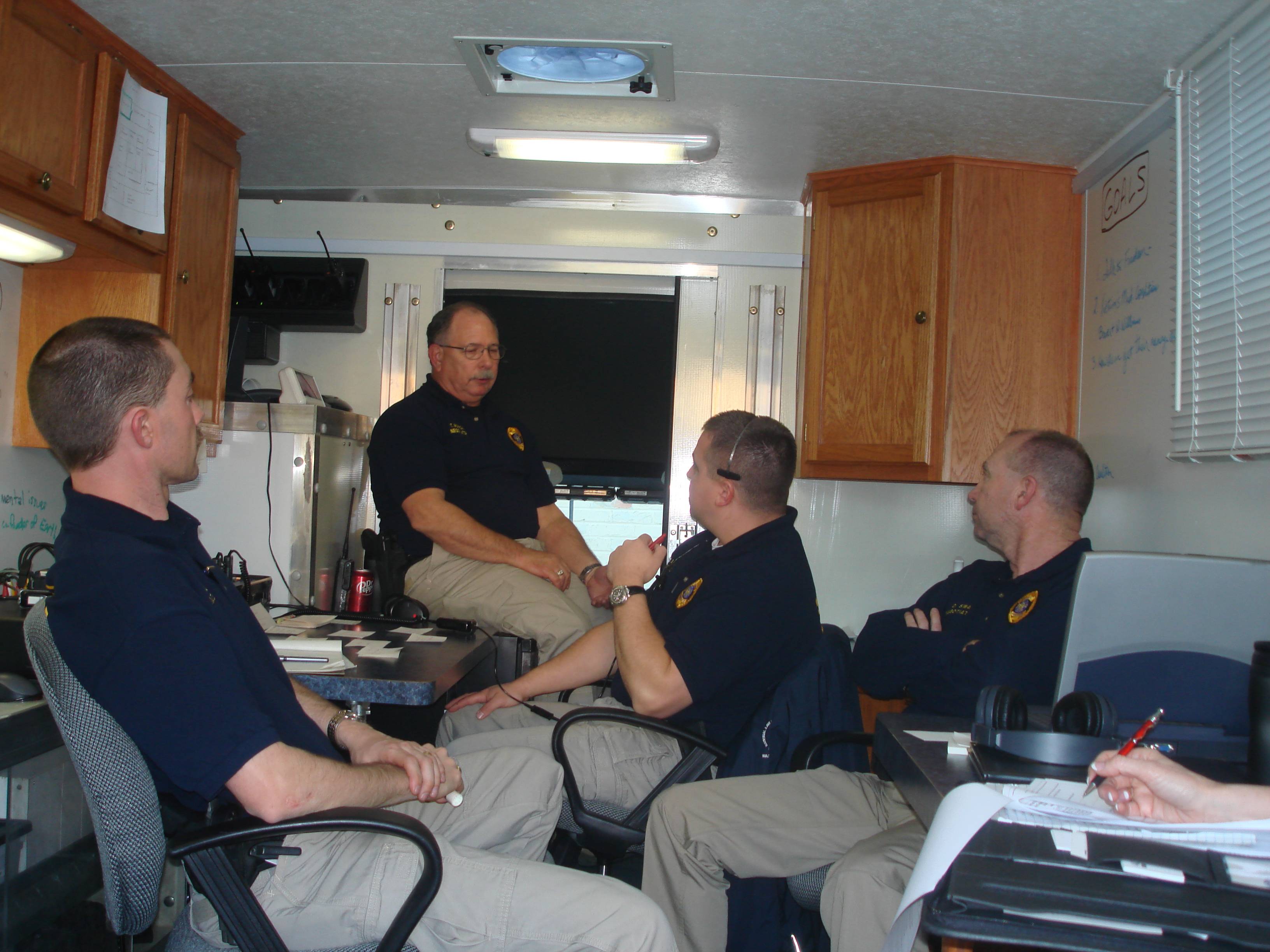 A group of negotiators sit together in a mobile unit