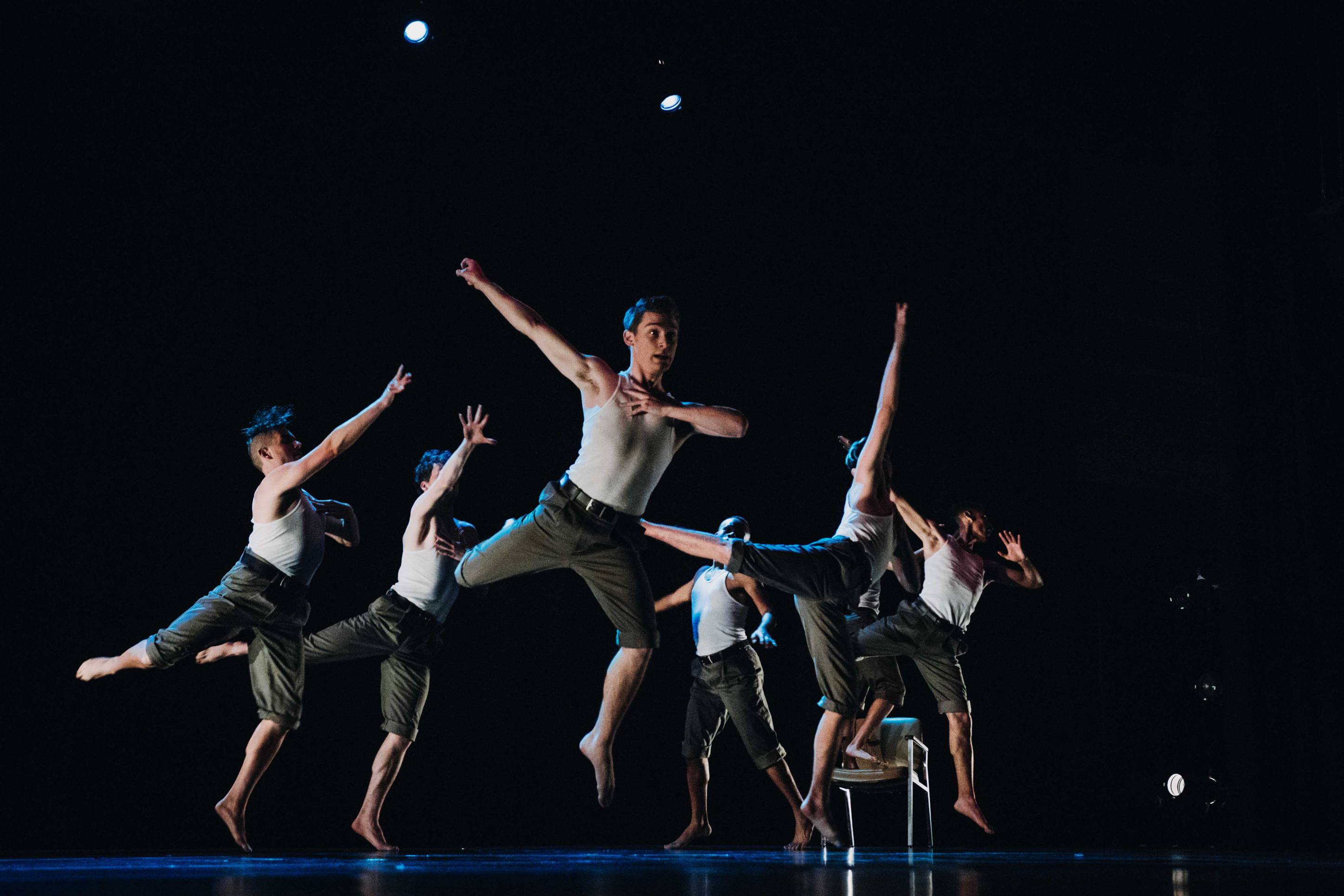 Group of dancers leaping across stage at Texas State