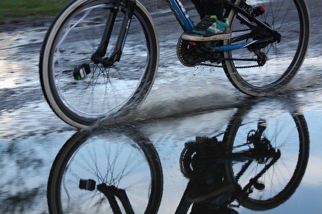 Bike riding through a puddle