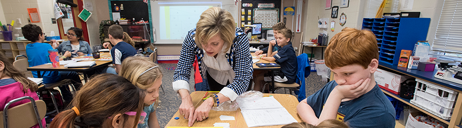 Professor teaching children