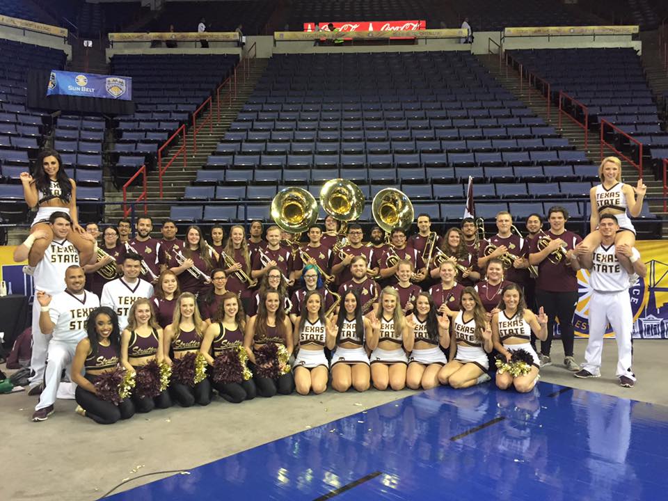 Image of band members and cheerleaders on basketball court