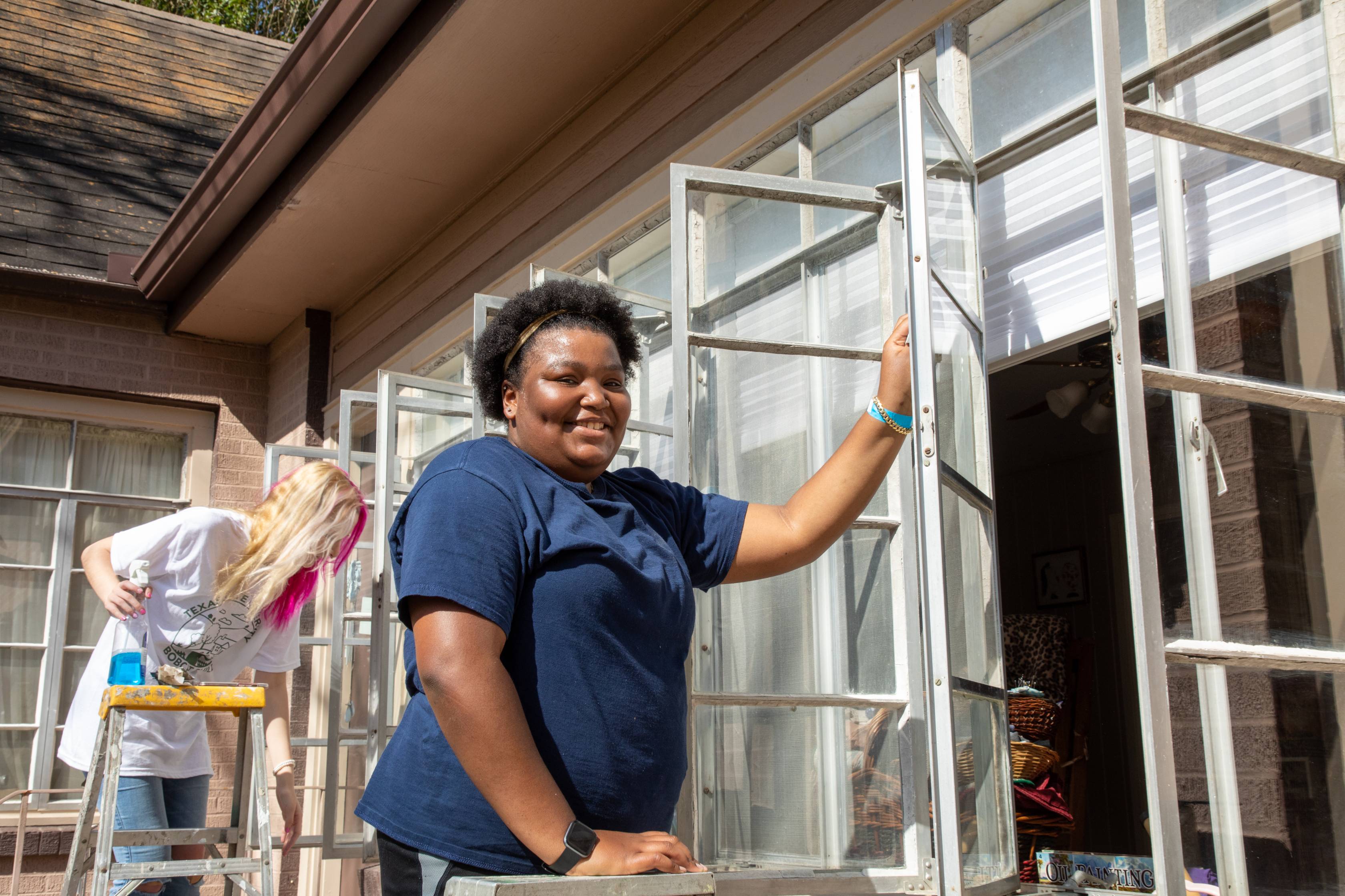 Volunteer cleaning window
