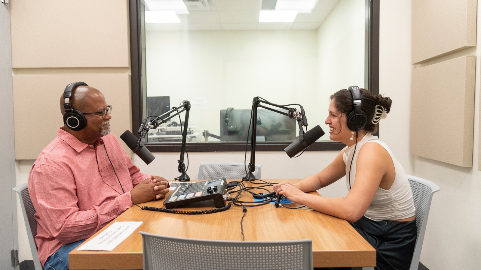 Two Texas State University staff members using the podcast equipment in Alkek One