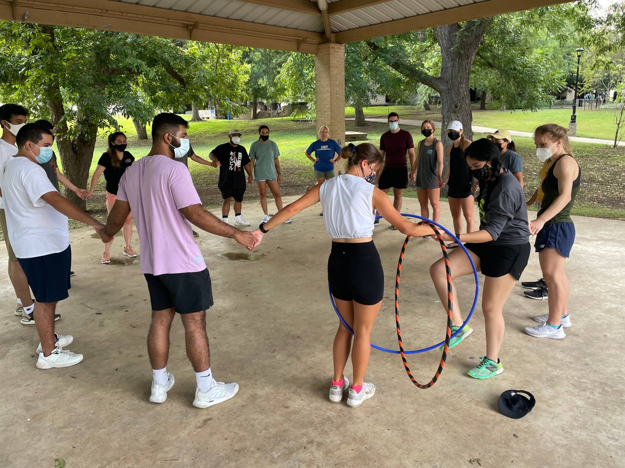 Team building participants with a hula hoop