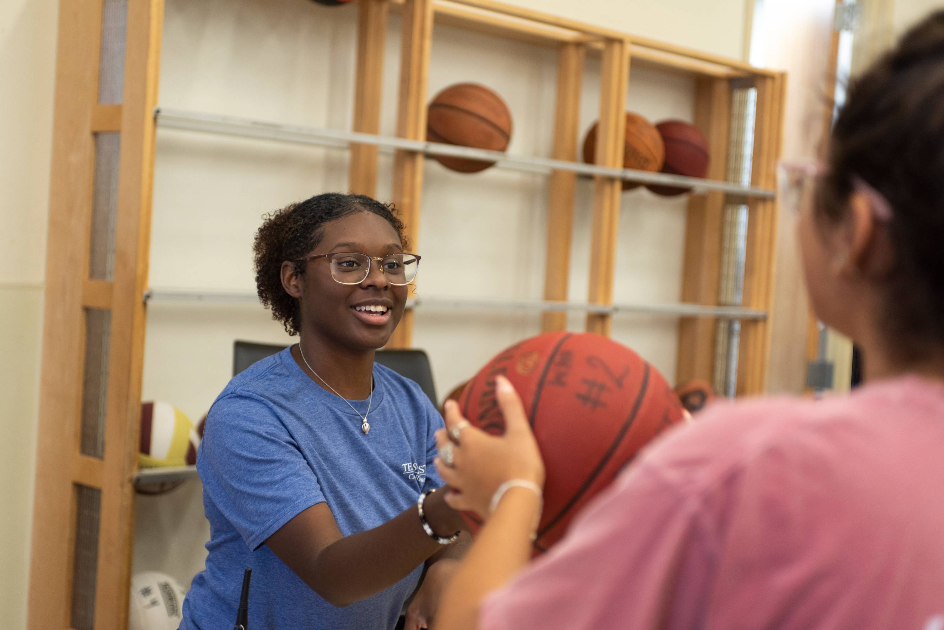 A student employee renting out a basketball
