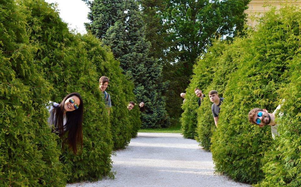 Students hiding between trees abroad