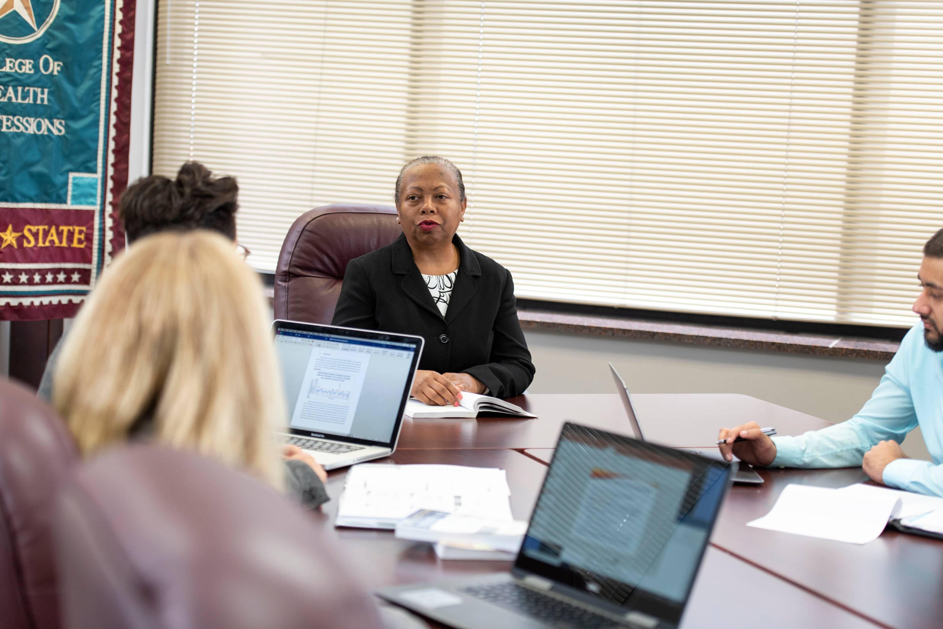 Dr. Zo in a meeting with M.H.A. students