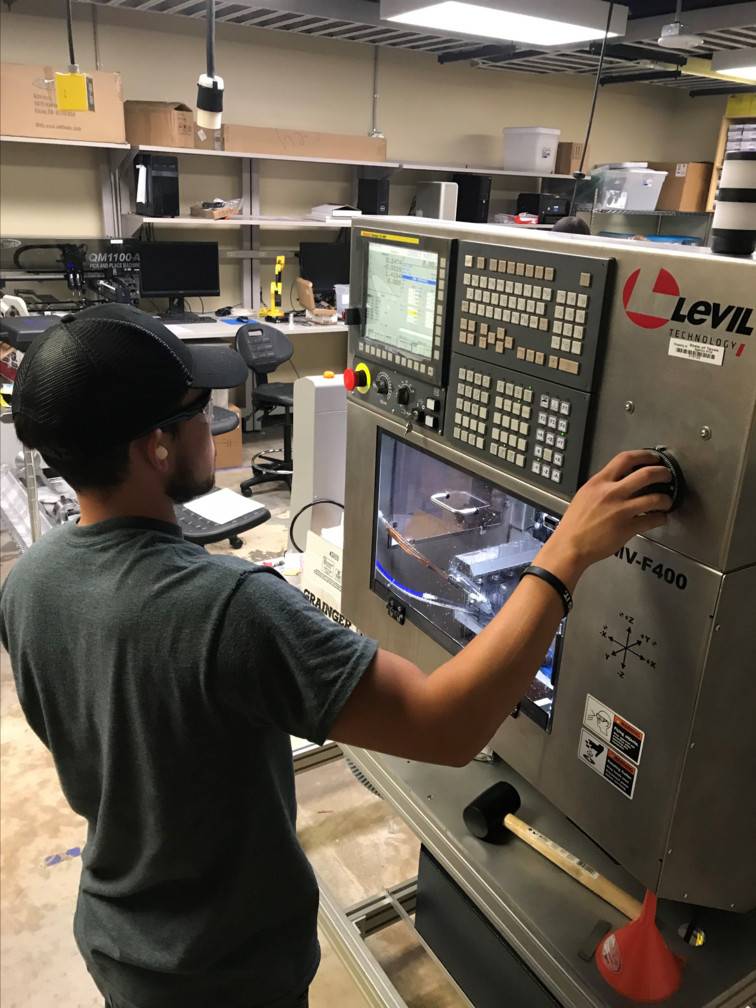 Student using a machine in the Advanced Prototyping Lab.