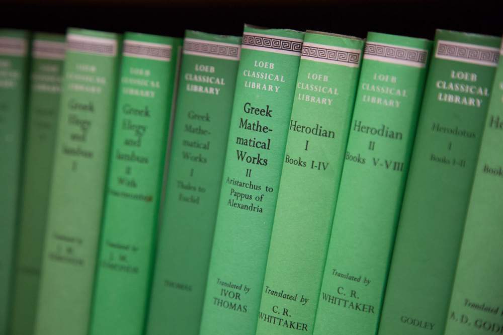 photo of green books on a shelf