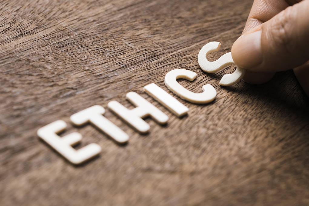 wooden letters reading 'ethics' on table