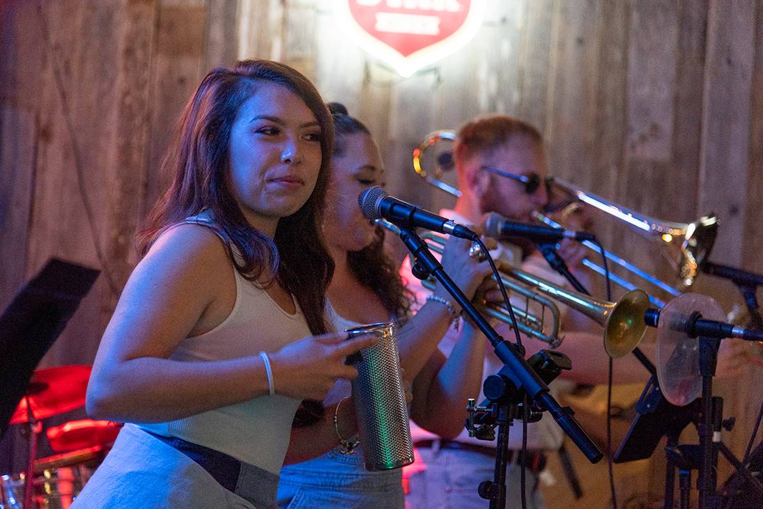 woman band member playing metallic instrument