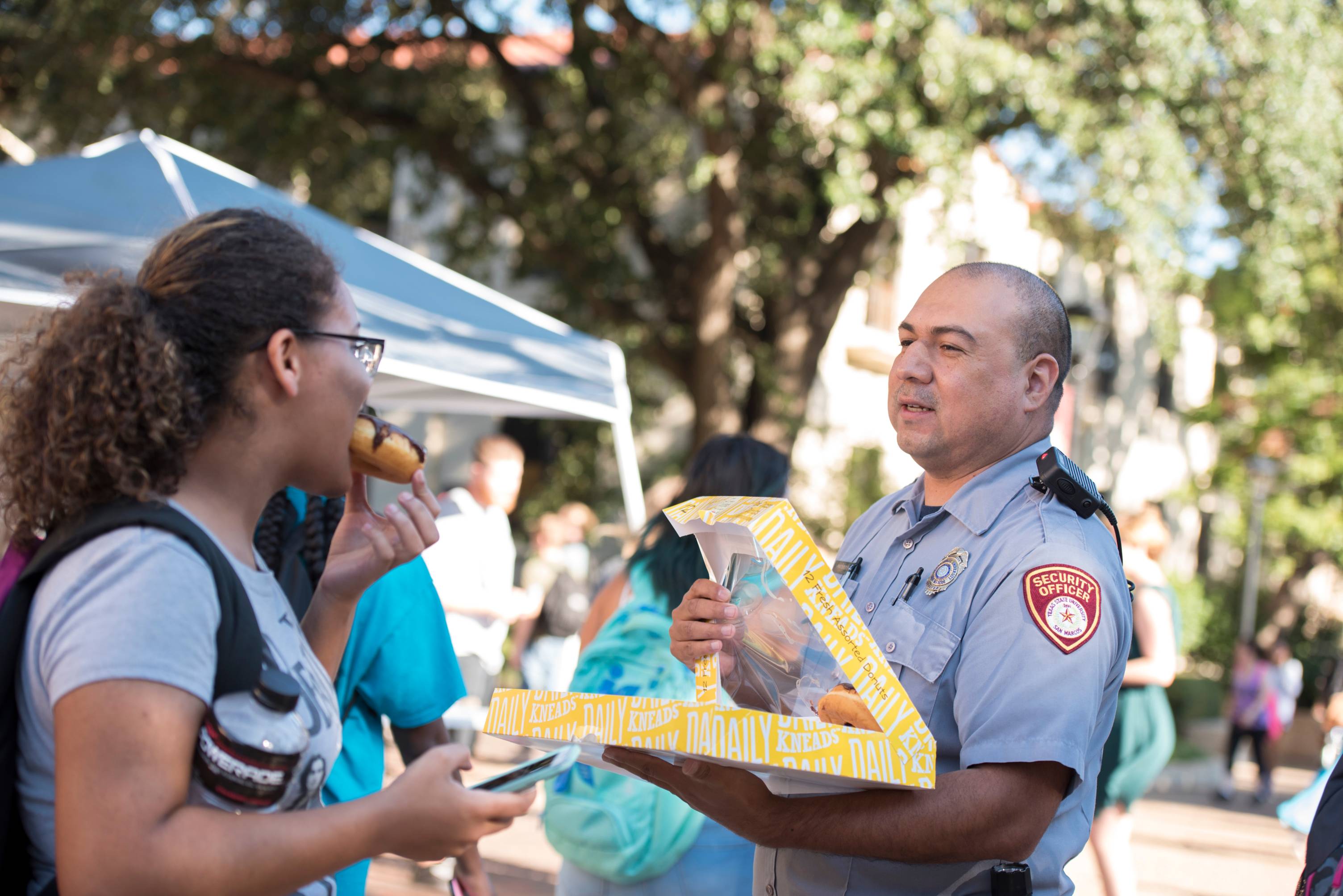 Police officers handing out donuts on the quad