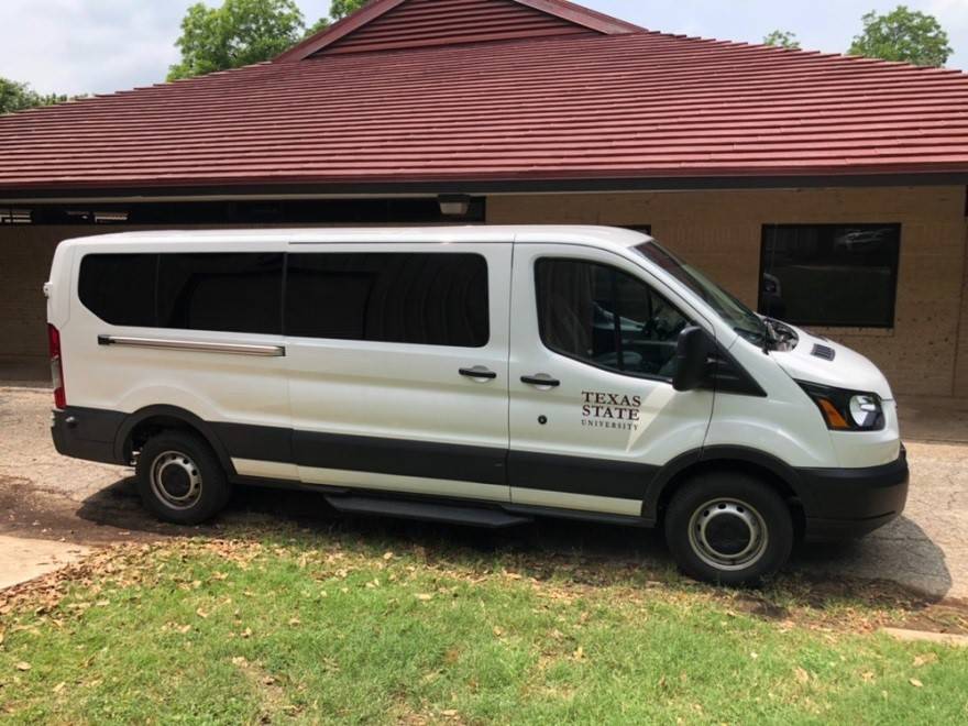 15 passenger van parked behind the Outdoor Center at Sewell Park