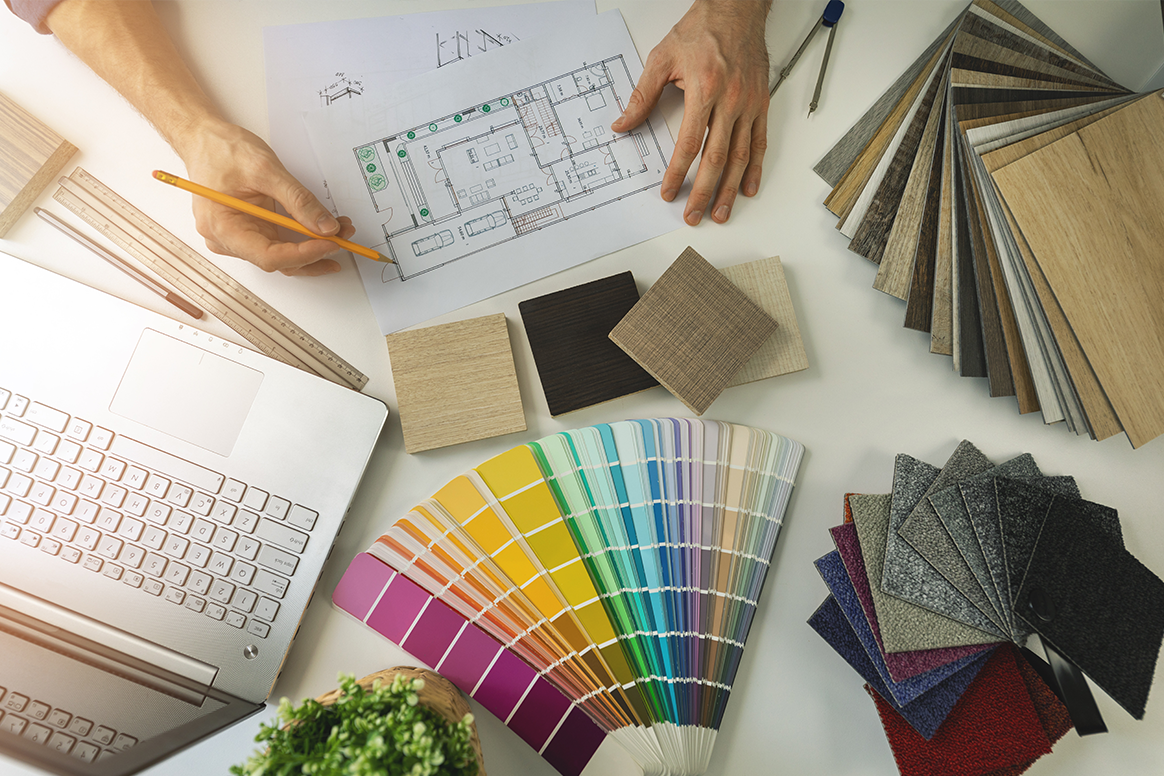 A table with color swabs and design materials on it. 