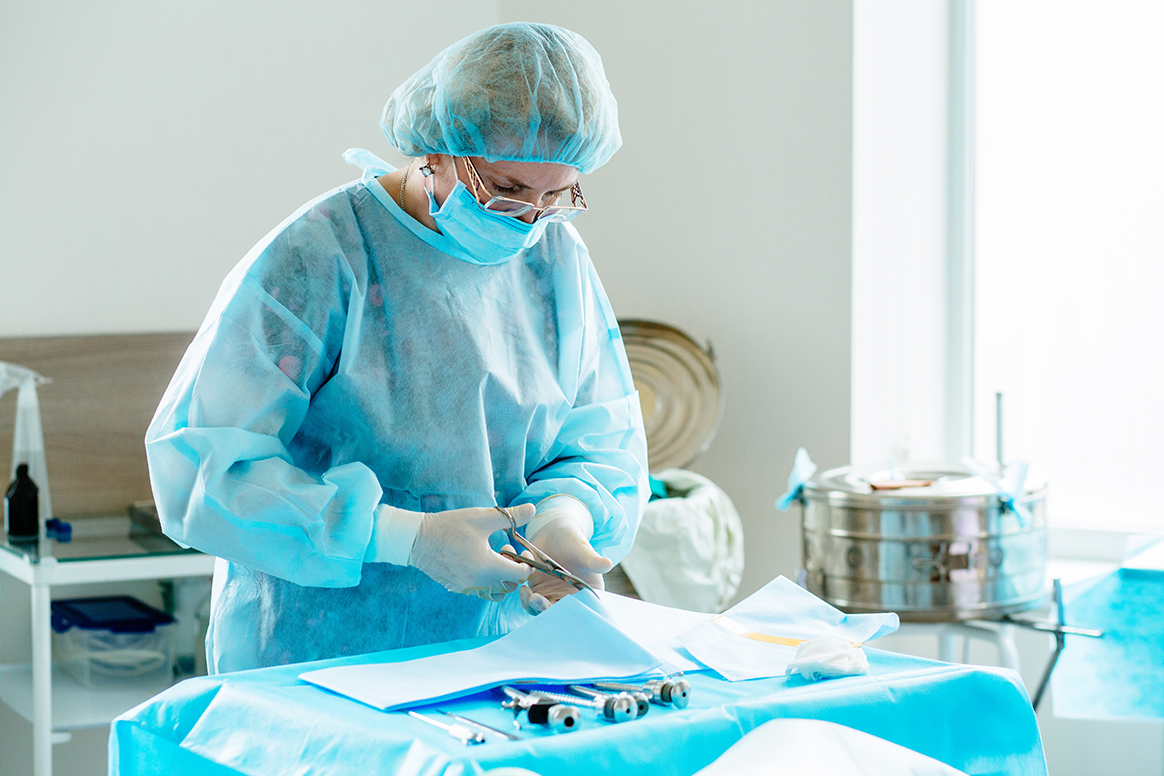 A sterile processing worker cleaning surgical tools. 
