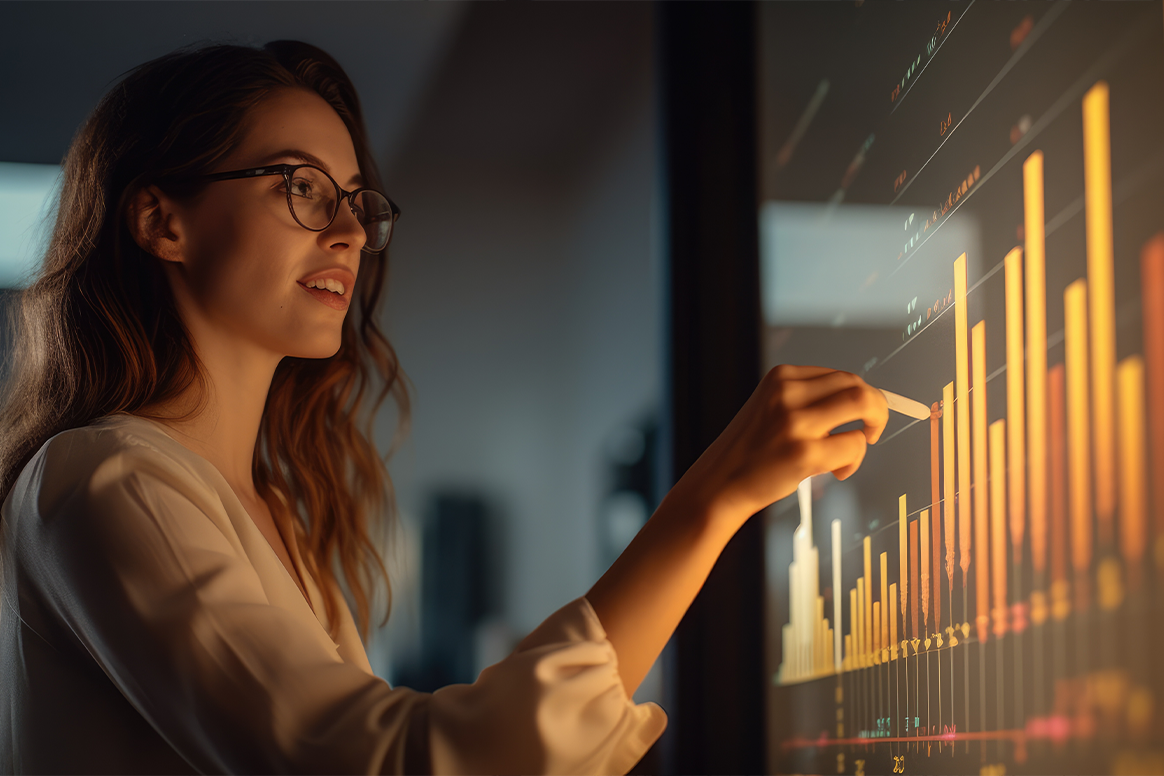 Woman standing in front of a screen with marketing information on it. 