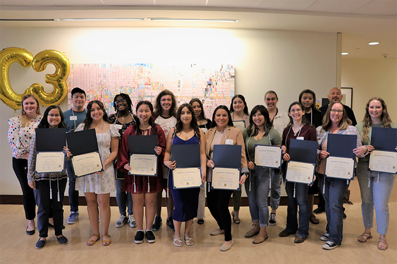 Students standing with certificates at C3 Ceremony