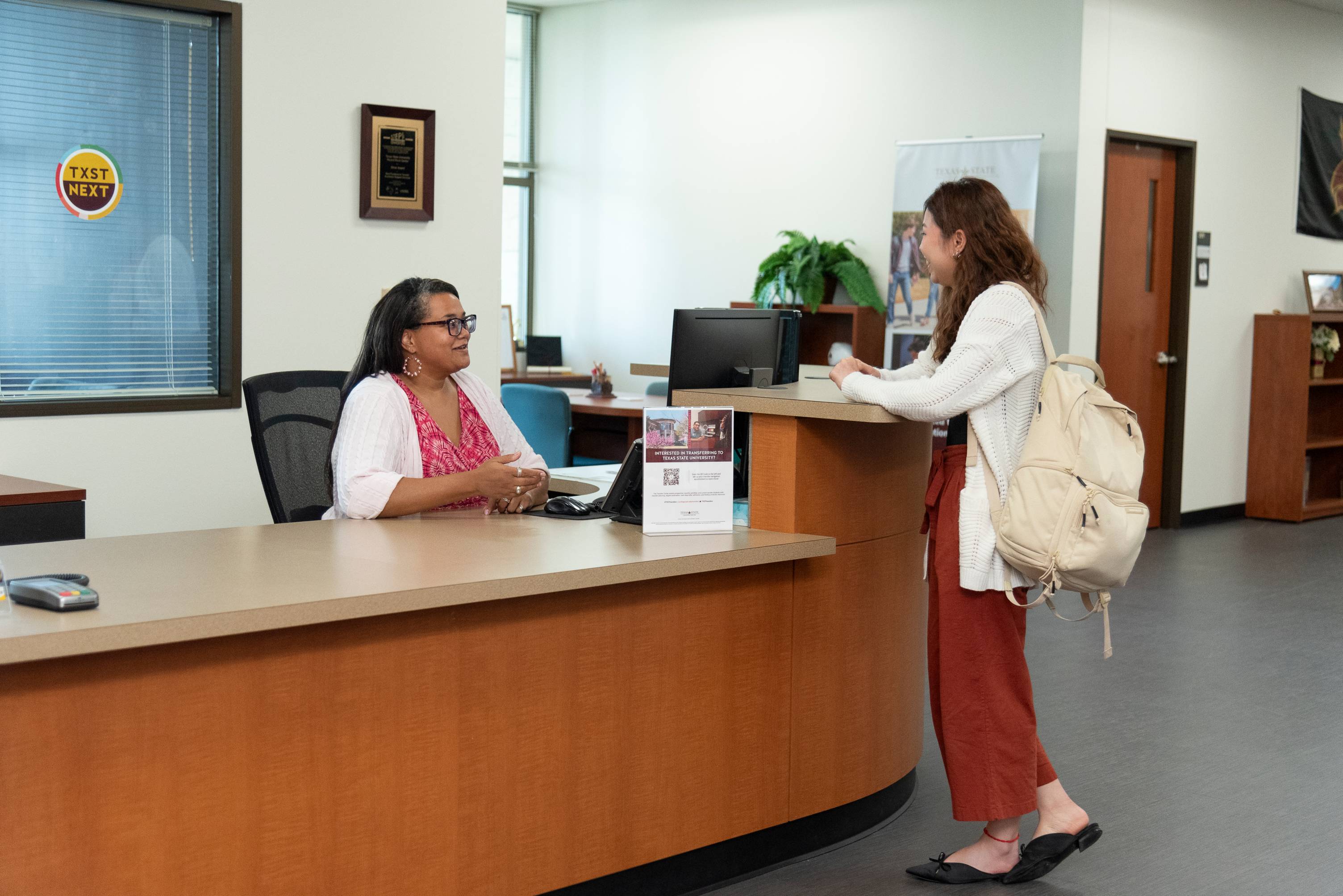 front desk staff talking to a student