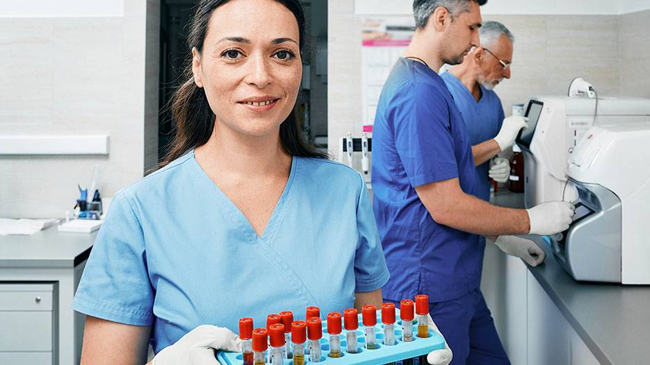 nurse holding test tubes