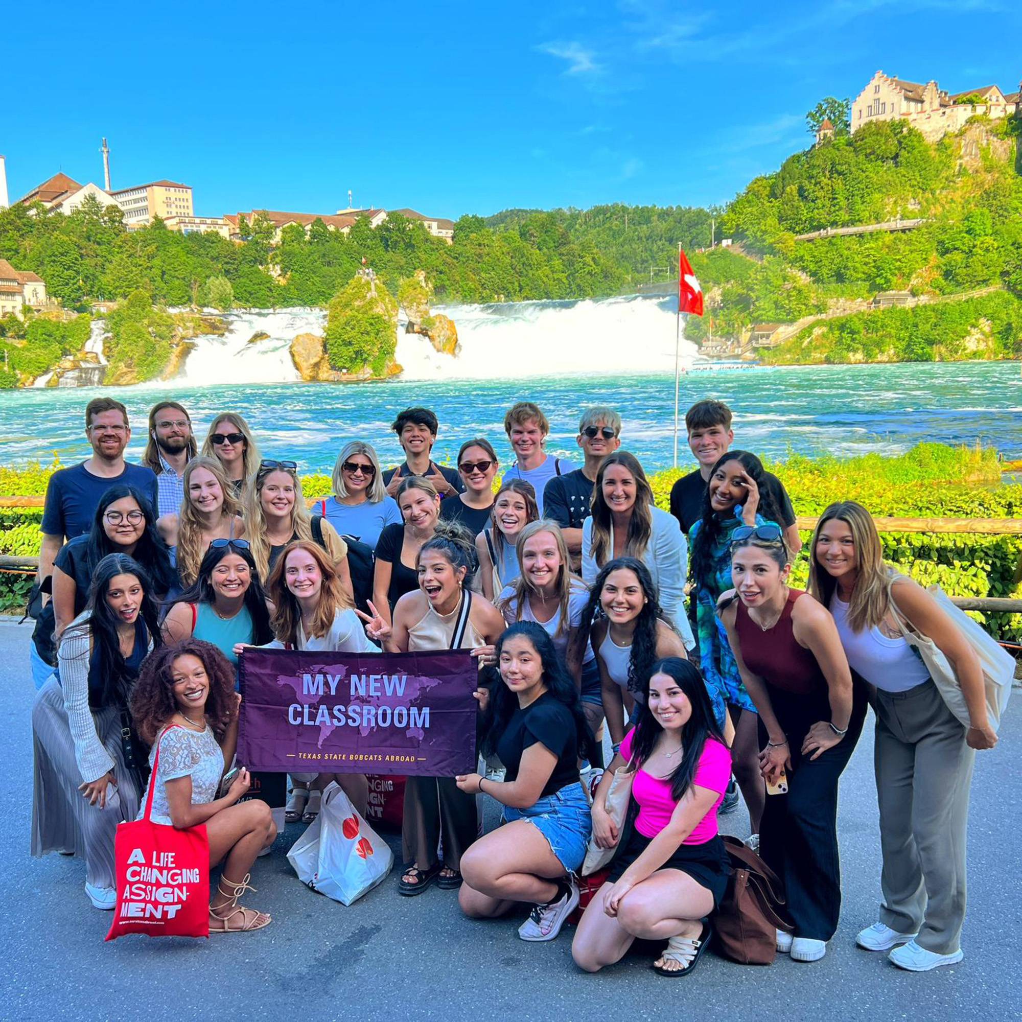 Students and faculty in front of waterfall in Portugal