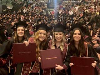 students in caps and gowns