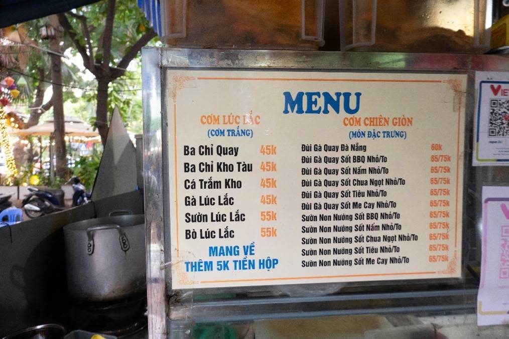 Picture of outdoor menu for crispy fried rice restuarant written in Vietnamese. Sign is 2 feet by three feet in size.