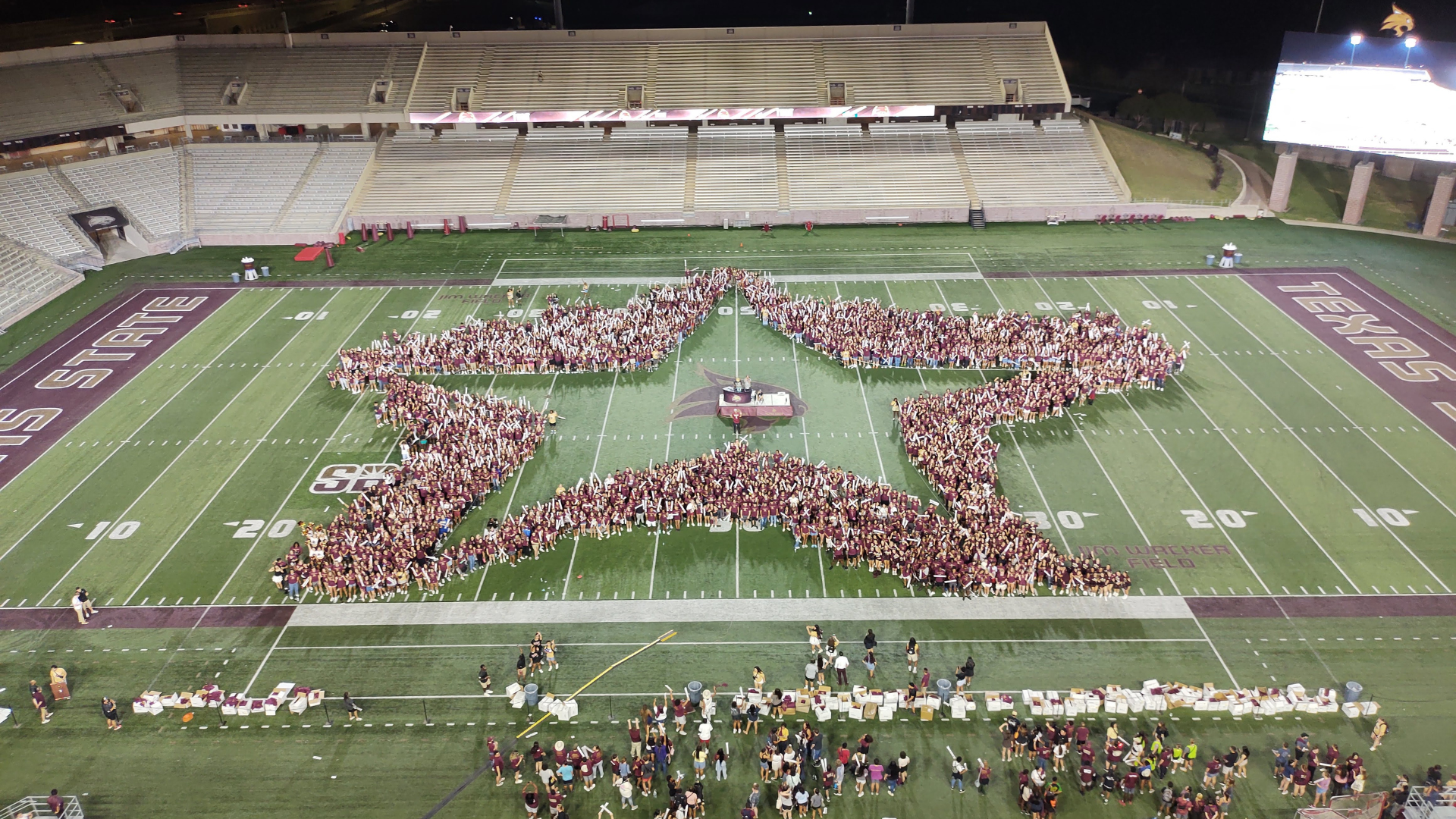 Texas State University Class of 2027 on Bobcat Stadium field in the shape of a star