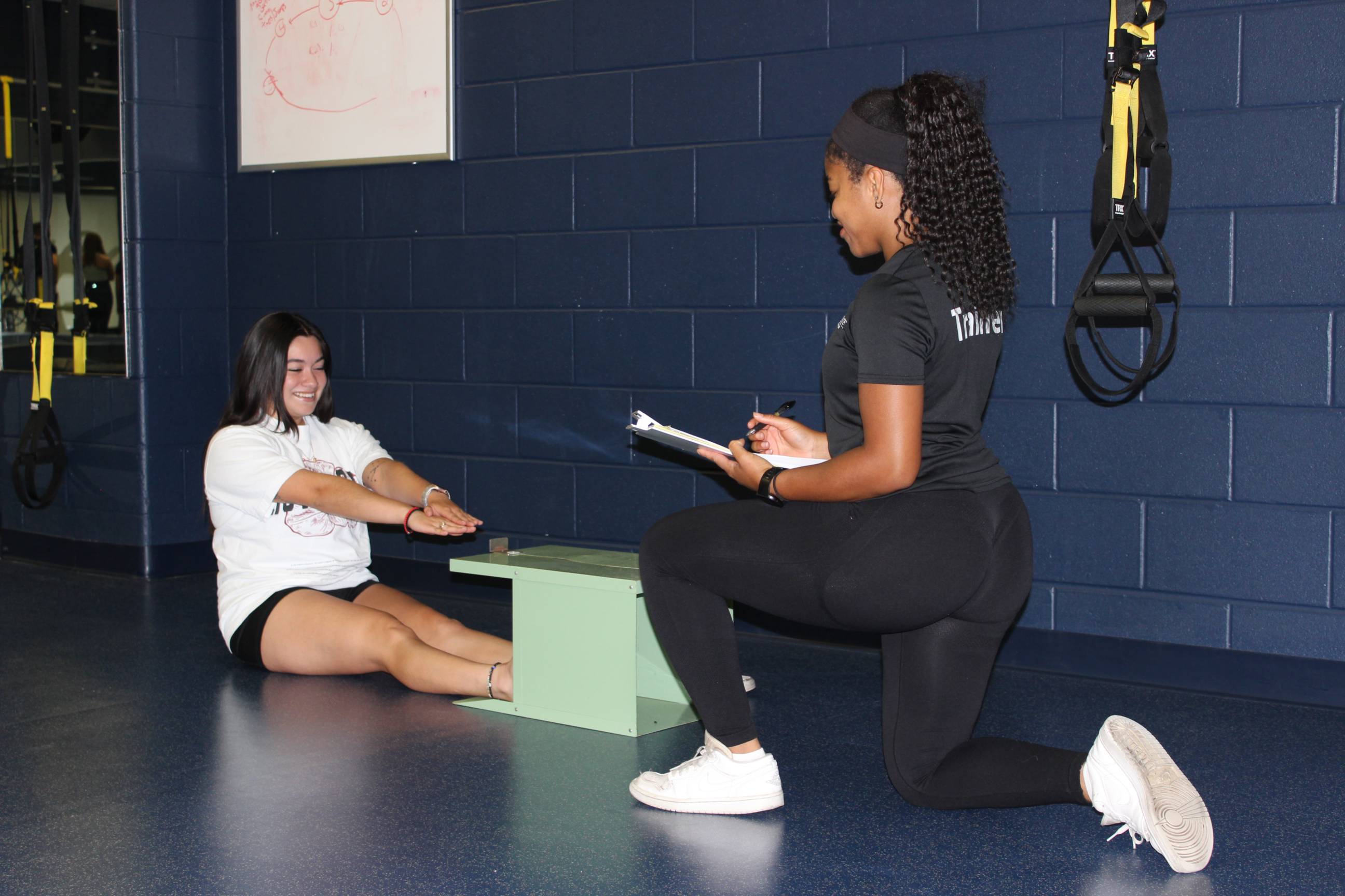 A trainer assessing a student
