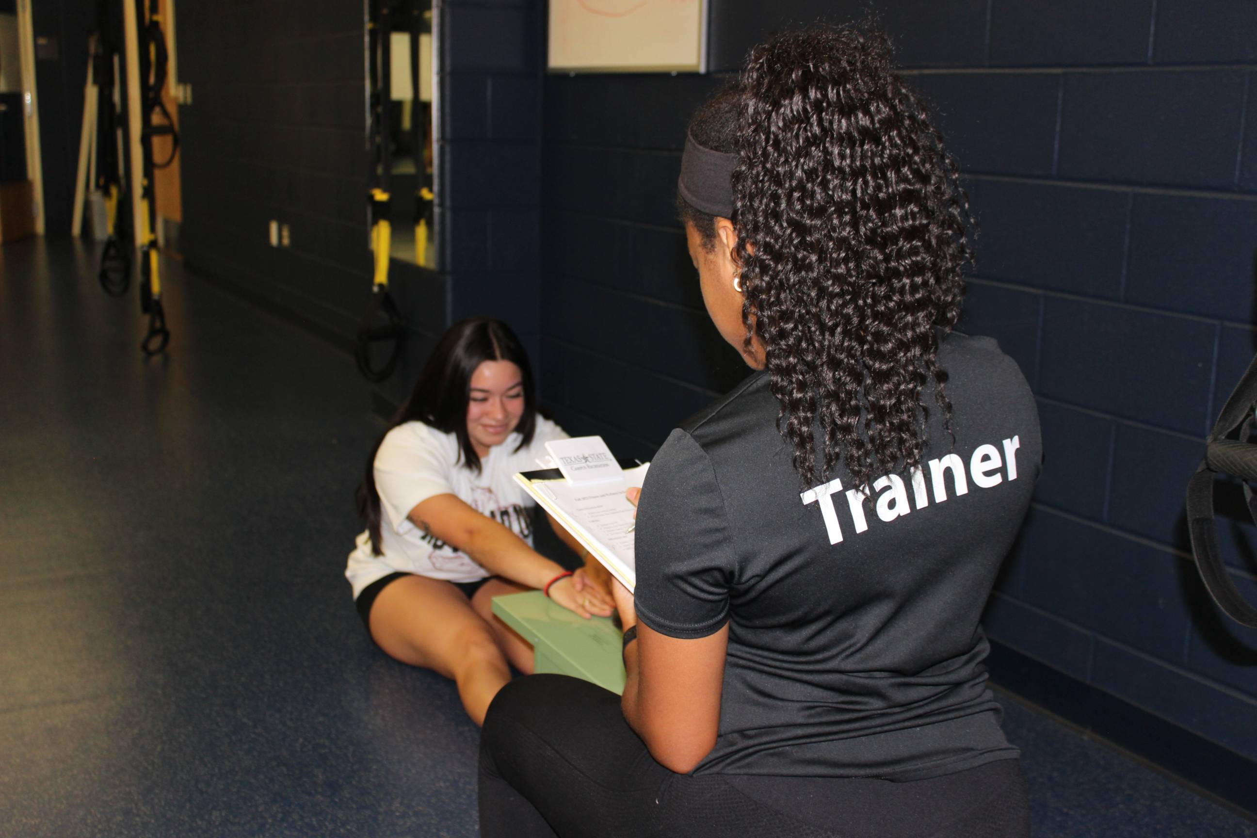 A trainer assessing a studnet