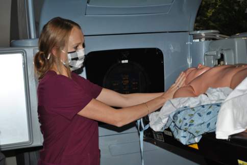 Student in Radiation Therapy's dosimetry lab with a manikin