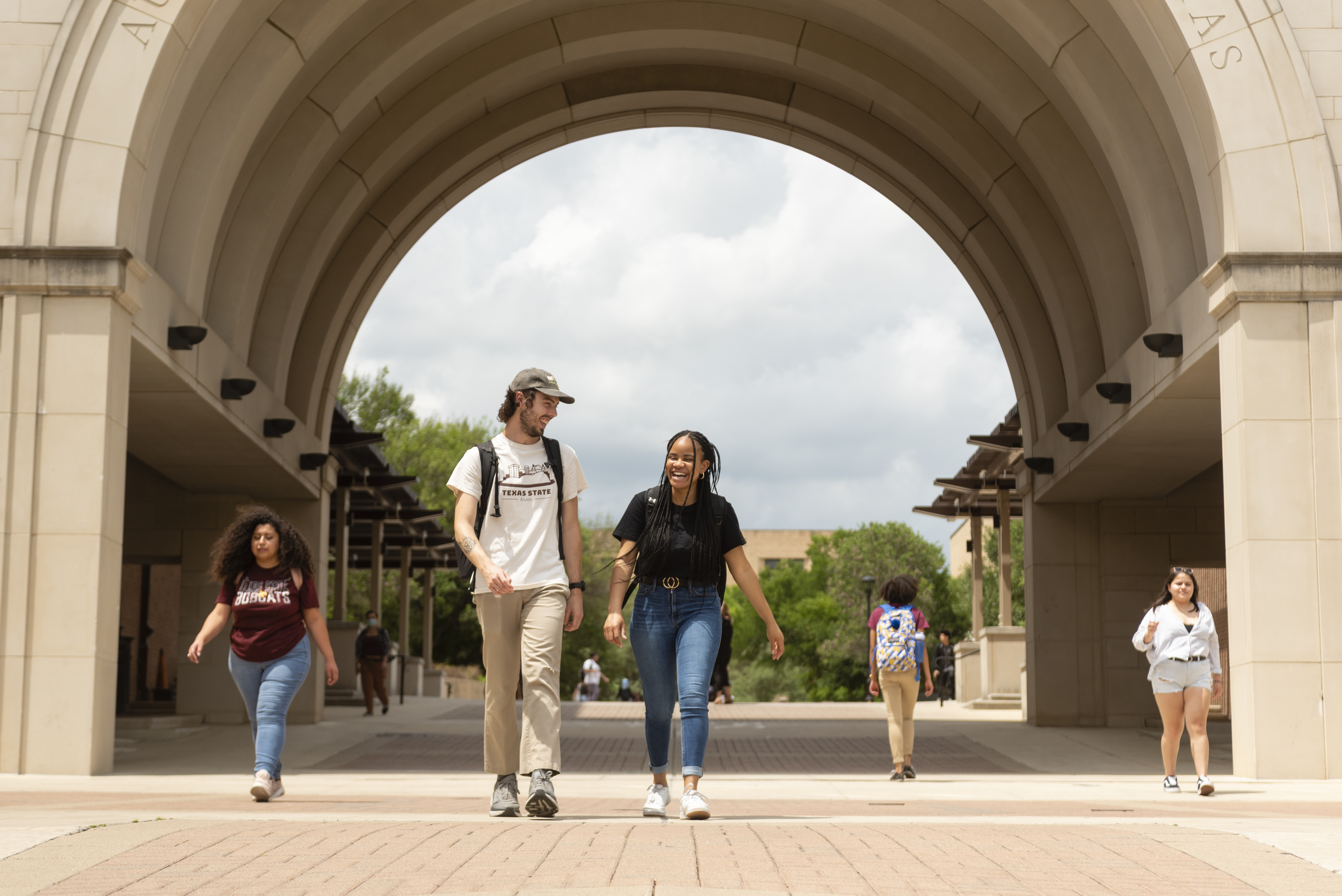 Students walking under the arch