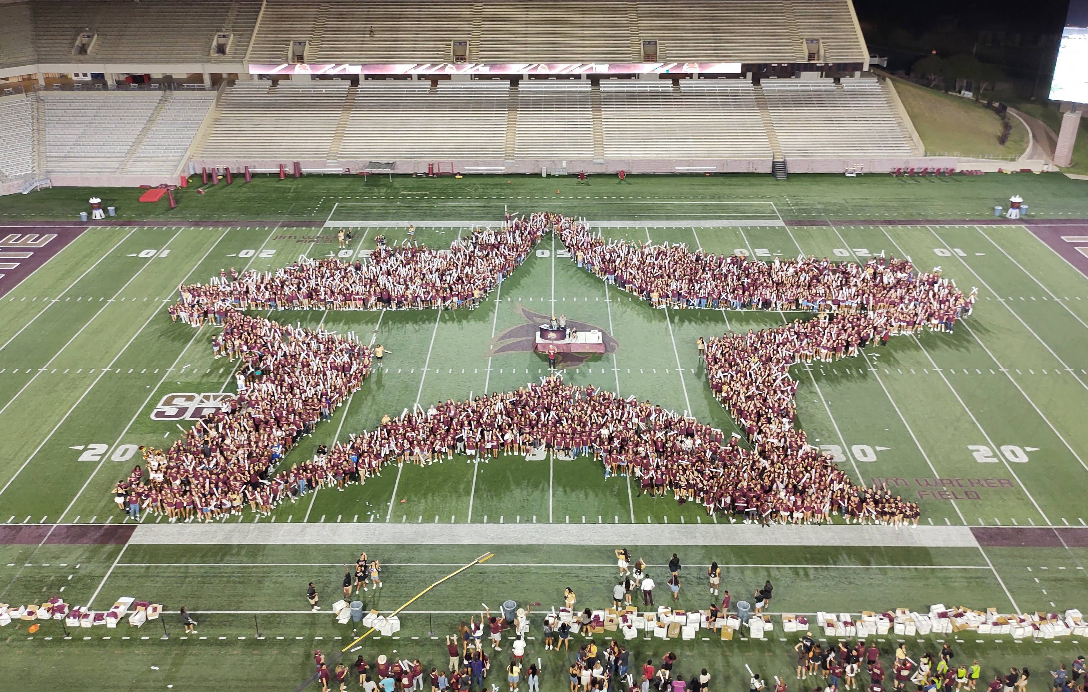 students making star on football field