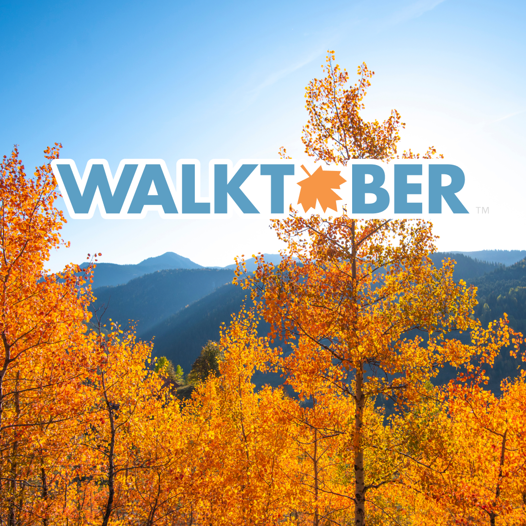 A landscape with fall leaves in the foreground and the word Walktober superimposed.