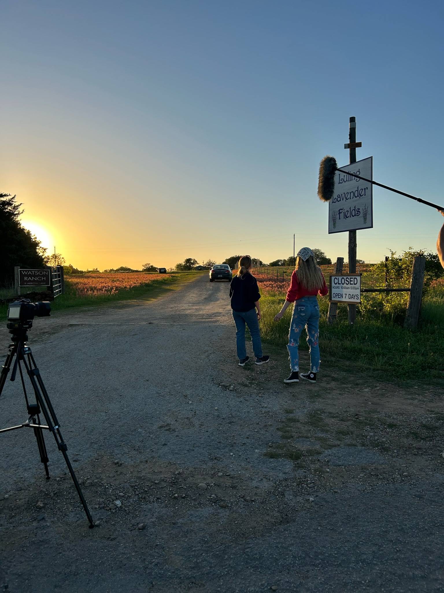 students in a field shooting a short film