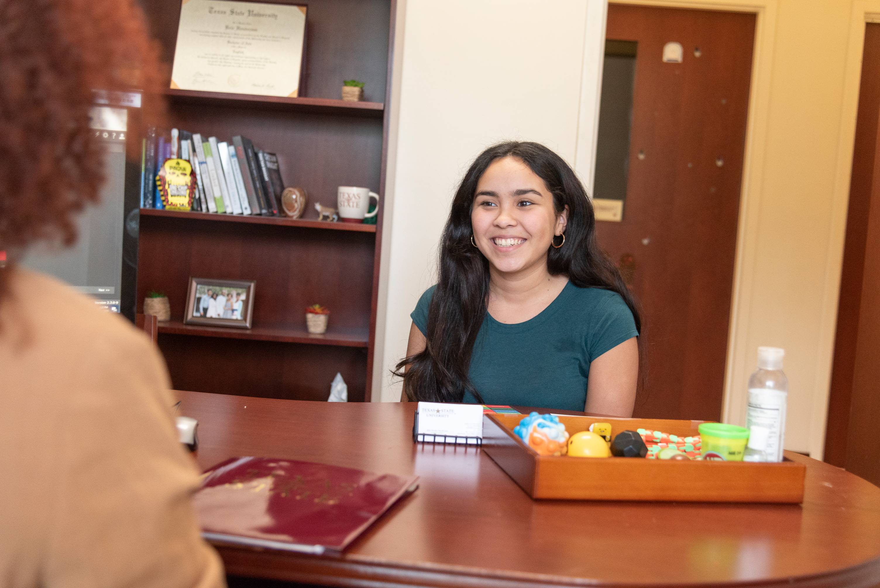 Student smiling while meeting with First-Year Advisor